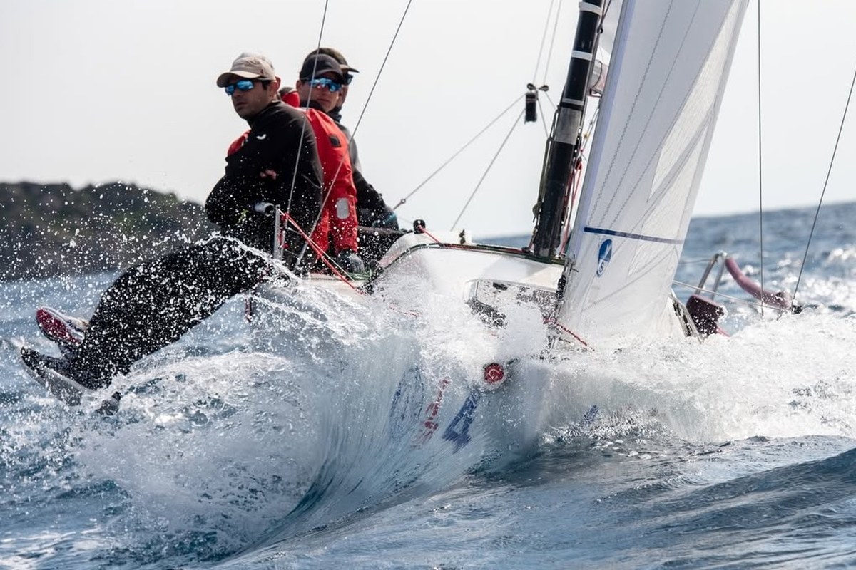 J/70 hull carving through a breaking wave